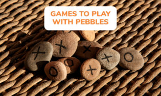 An image of some pebbles with x's and o's on them with text that reads games to play with pebbles. 