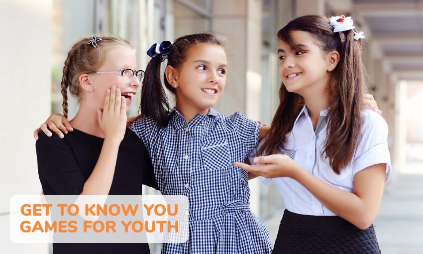 Three young girls one with her arms around the other two girls, laughing and talking. Text reads get to know you games for youth. 