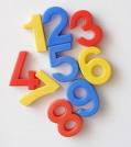 A picture of foam numbers in different colors like red, blue, and yellow with a white background. 