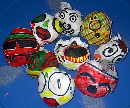 An image of DY beanbags with different art design on them. Lots of various faces drawn by kids. 