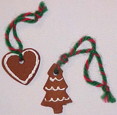A picture of a heart and Christmas tree shaped ornament made from gingerbread cinnamon dough