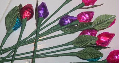 A picture of an art and craft project where Hershey's kisses are used to represent the rose bud and attached to flower stems. About a dozen flowers. 