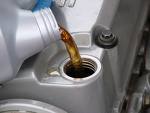 A picture of oil being poured into an engine. 