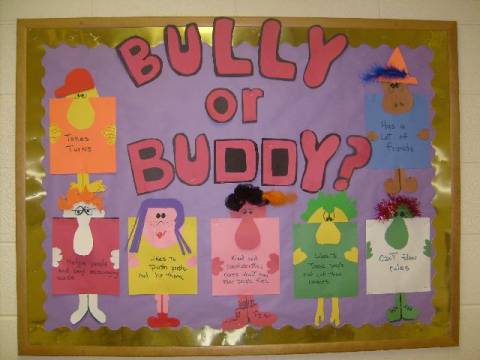 A bulletin board with six different characters on it made from construction paper. Each character has words or phrases on it. The heading is "bully or buddy?" 