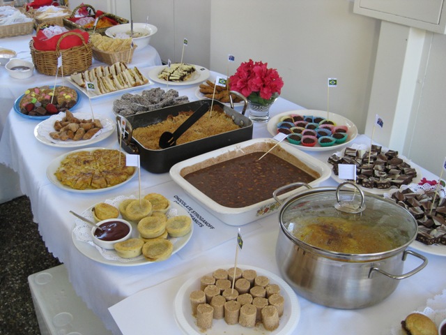 An 8ft table lined with different types of diverse foods.