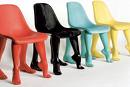 A picture of 4 different colored chairs: red, black, green, and yellow. 