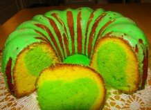 A picture of a cake with green glaze and green center. 