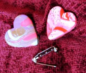 An image of two hearts in pinks and reds made from play dough. 