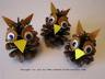 Three pinecones crafted to look like birds. Yellow construction paper beaks and googly eyes. 