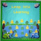 A frog themed bulletin board. A picture of frogs in a lake and lily pads with a heading that says Lean into Learning. 