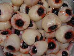 A picture of litchis with cherries inside. It has the appearance of eyeballs. 