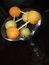 A picture of melon balls connect by toothpicks giving it the appearance of a molecule. 