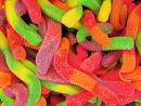 A picture of a lot of gummy worms in a pile. 