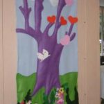 An art project shows a purple tree, red and pink hearts as leaves, and white birds flying past. Blue sky as the background. 