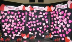 A wall of love display project. At the top it says wall of love and below are lots of different shades of pink and red heart cutouts.  