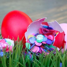 An image of a confetti egg cracked open showing the confetti inside. 