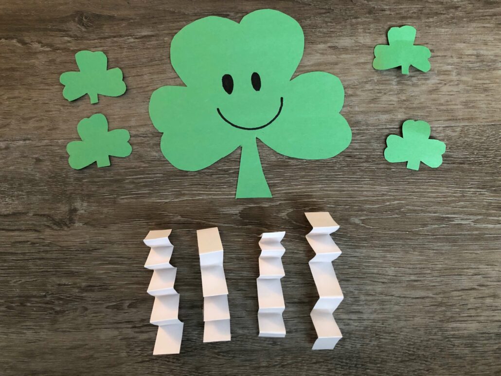 The paper crinkled limbs and smiley face not the shamrock cutouts. 