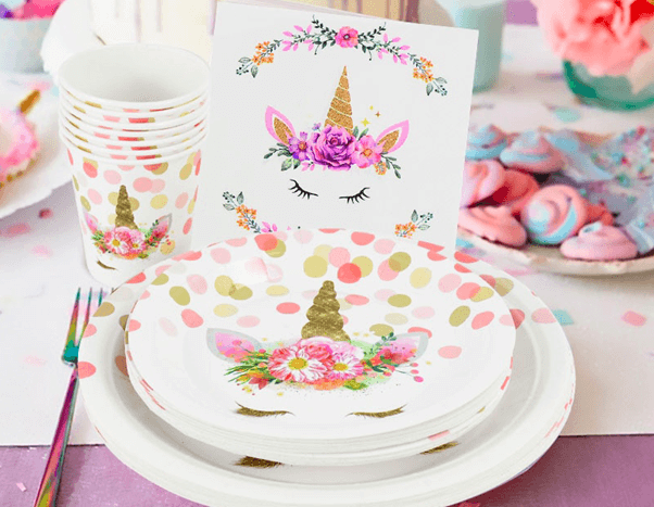 set of unicorn-themed plates, cups, and utensils