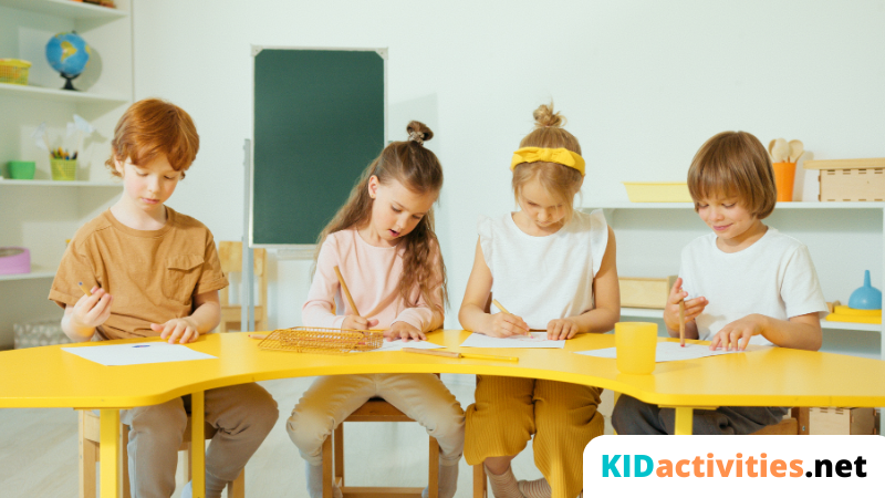 Four kids are sitting in a classroom and doing an activity on paper.