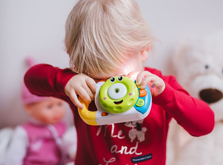 baby playing with a toy steering wheel