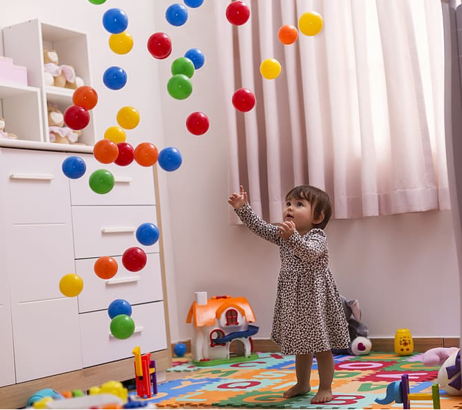 girl baby playing with balls
