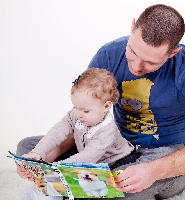 father and baby reading together 
