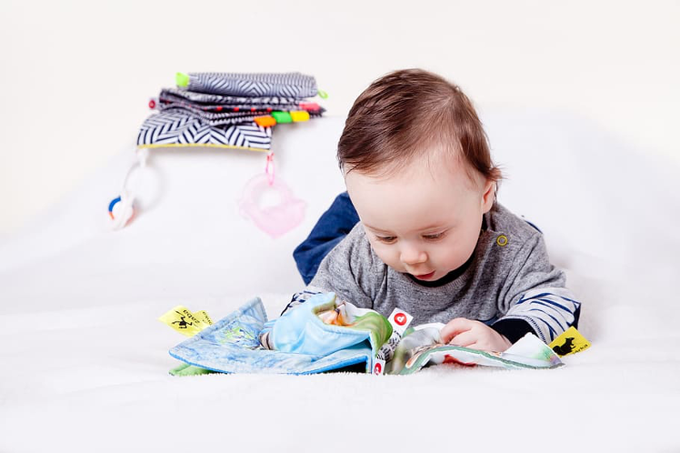 baby reading a fake toy book