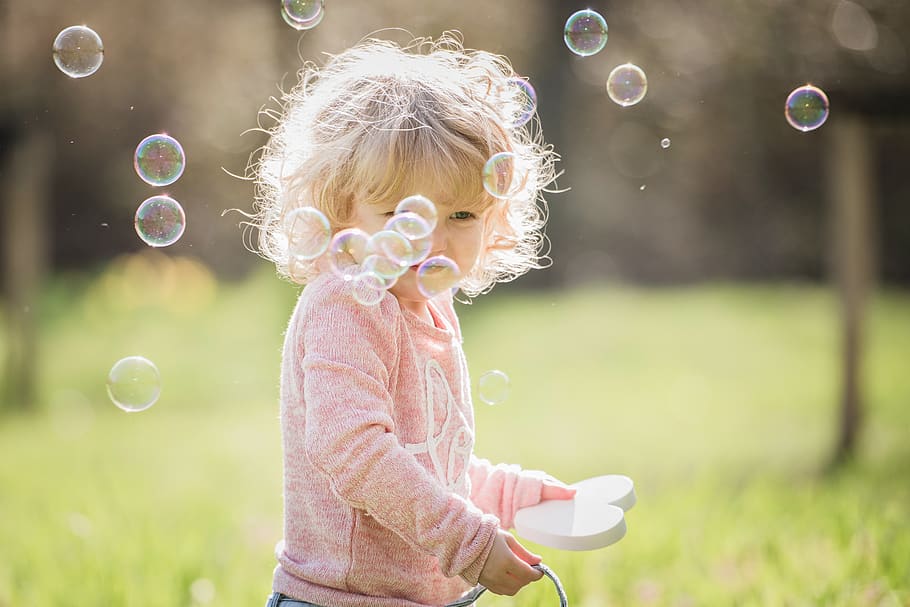 baby playing with soap bubbles